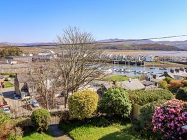 A view of boats in a marina and houses at Garth Celyn in Porthmadog