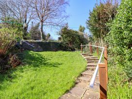 A garden with steps leading up to grass at Garth Celyn Porthmadog