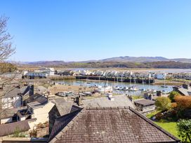 A view of boats and buildings near water at Garth Celyn in Porthmadog