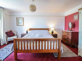 A bedroom with a bed and nightstand at Garth Celyn in Porthmadog