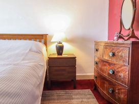 A bedroom with a bed and nightstand at Garth Celyn in Porthmadog