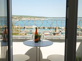 A balcony with a table and champagne at Kittiwake Newlyn