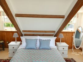 A bedroom with a bed and a mirror at Kittiwake in Newlyn