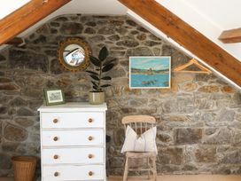 A room with a chest of drawers and a chair at Kittiwake in Newlyn