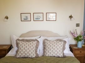 A bedroom with a bed and pillows at Kittiwake in Newlyn