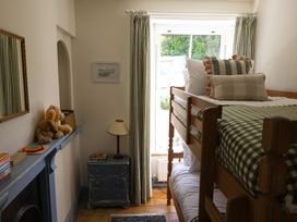 A bedroom with a bunk bed and stuffed animal at Kittiwake in Newlyn