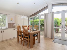 A dining room with a table and chairs at Newton Calm in Newton Ferrers