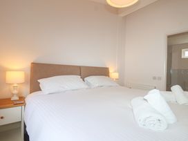 A bedroom with a bed and bedside table at Newton Calm in Newton Ferrers