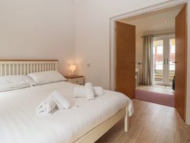 A bedroom with a bed and door leading outside at Newton Calm in Newton Ferrers