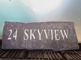 A slate sign with the number 24 and the text Skyview