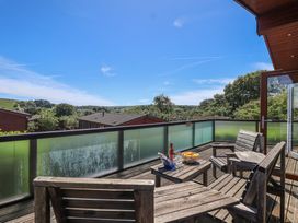 Outdoor seating area with wooden chairs and table at Skyview in Newton Ferrers