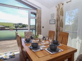 A dining room with a table set for meals at Skyview in Newton Ferrers