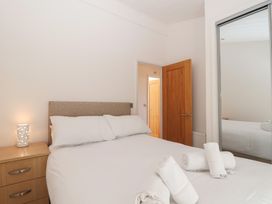 A bedroom with a bed and bedside table at Skyview in Newton Ferrers