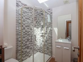 A bathroom with a shower, toilet, and sink at Skyview in Newton Ferrers