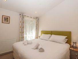 A bedroom with a bed and window at Skyview in Newton Ferrers