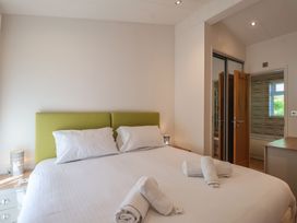 A bedroom with a bed and towels on the bed at Skyview in Newton Ferrers