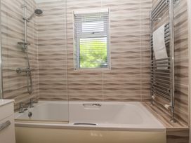 A bathroom with a bathtub and shower at Skyview in Newton Ferrers