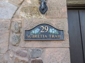 A house number plaque 29 Aubretia Trail on a stone wall at Aubretia Trail Akeld near Wooler