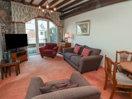 A living room with sofas a television and dining table at Aubretia Trail in Akeld near Wooler