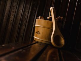 A wooden bucket and ladle in a sauna at Bizzie Lizzie Akeld near Wooler