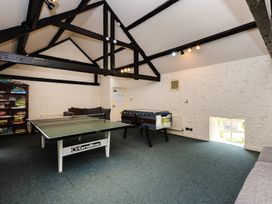 A game room with a table tennis table and foosball table at Bizzie Lizzie in Akeld near Wooler