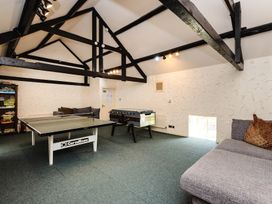 A recreation room with a ping pong table and foosball table at Bizzie Lizzie Akeld near Wooler