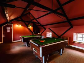 A game room with two pool tables at Bizzie Lizzie Akeld near Wooler