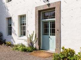 A door with windows and plants at Cheviot Manor in Akeld near Wooler