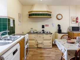 A kitchen with a stove and table at Cheviot Manor Akeld near Wooler