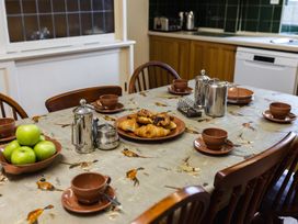 A kitchen with a table set for breakfast at Cheviot Manor in Akeld near Wooler