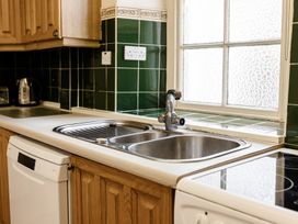 A kitchen with a sink and dishwasher at Cheviot Manor in Akeld near Wooler