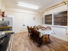 A kitchen with a dining table and chairs at Cheviot Manor in Akeld near Wooler