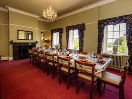 A dining room with a large table set for a meal at Cheviot Manor in Akeld near Wooler