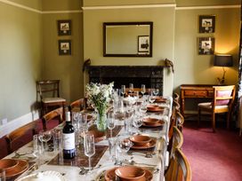 A dining room with a large table set for a meal at Cheviot Manor Akeld near Wooler