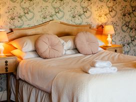 A bedroom with a bed and bedside tables at Cheviot Manor Akeld near Wooler