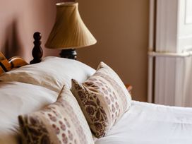 A bedroom with a bed and lampshade at Cheviot Manor in Akeld near Wooler