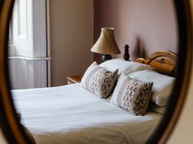 A bedroom with a bed and lamp at Cheviot Manor Akeld near Wooler