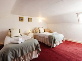 A bedroom with two beds and a bedside table at Cheviot Manor in Akeld near Wooler