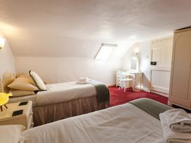 A bedroom with two beds and a vanity at Cheviot Manor in Akeld near Wooler