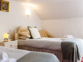 A bedroom with beds and a lamp at Cheviot Manor Akeld near Wooler