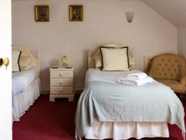 A bedroom with two beds and a nightstand at Cheviot Manor in Akeld near Wooler