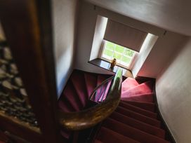A staircase with a handrail and a window at Cheviot Manor in Akeld near Wooler