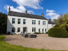 An outdoor seating area in front of a house at Cheviot Manor Akeld near Wooler