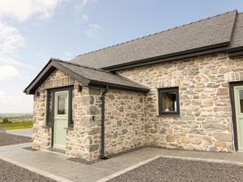 A stone exterior of a house with a door and window at Golygfa Cwrt near Bontgoch and Penrhyncoch