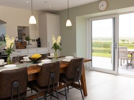 A kitchen with a dining table and chairs at Golygfa Cwrt near Bontgoch and Penrhyncoch