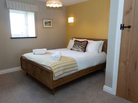 A bedroom with a bed and window at Golygfa Cwrt near Bontgoch and Penrhyncoch