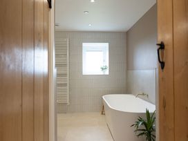 A bathroom with a bathtub and a window at Golygfa Cwrt near Bontgoch and Penrhyncoch