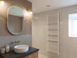 A bathroom with a wash basin and towel radiator at Golygfa Cwrt near Bontgoch and Penrhyncoch