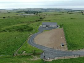 A house with a driveway and fenced area in a grassy field at Golygfa Cwrt Near Bontgoch and Penrhyncoch