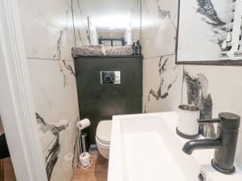 A bathroom with a wall-mounted toilet and modern sink at The Blacksmith's Shop in Staithes